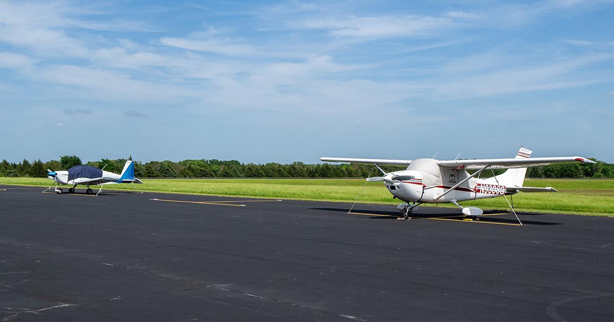 line of tie-down spaces with two aircrafts parked