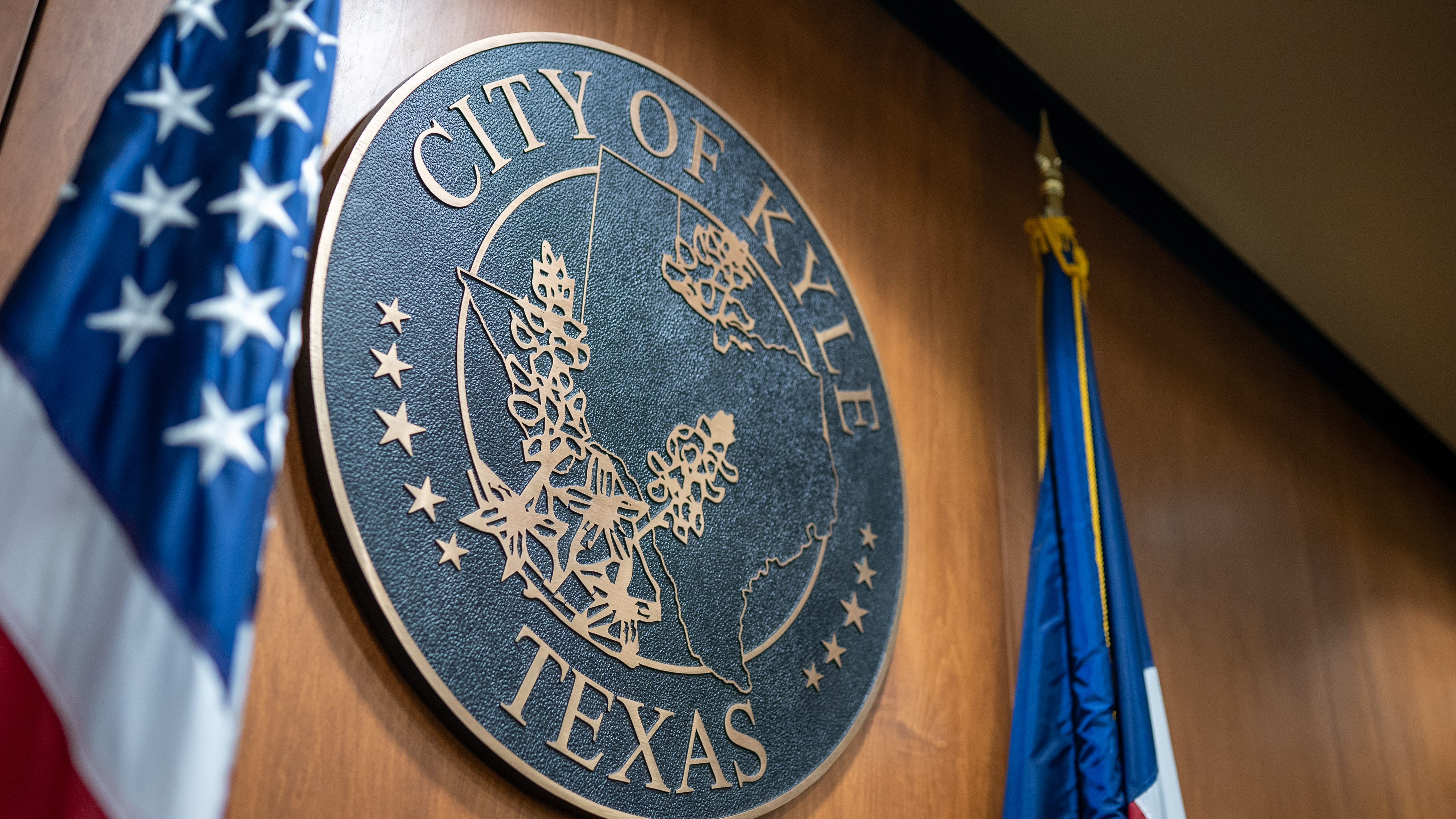 The City Seal of the City of Kyle on the wall of City Hall, above the dias.