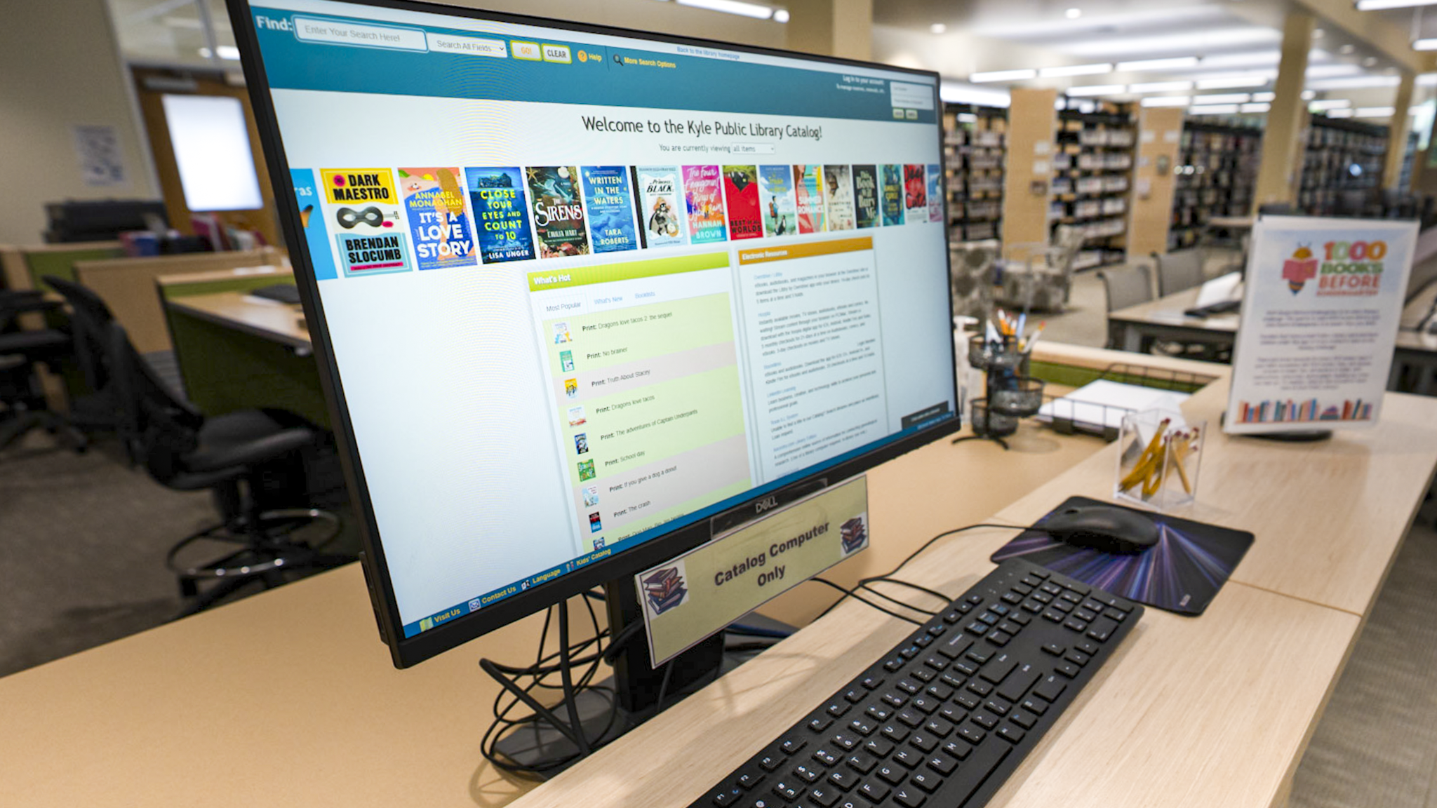 Computer at a desk displaying the Kyle Public Library catalog search home page.