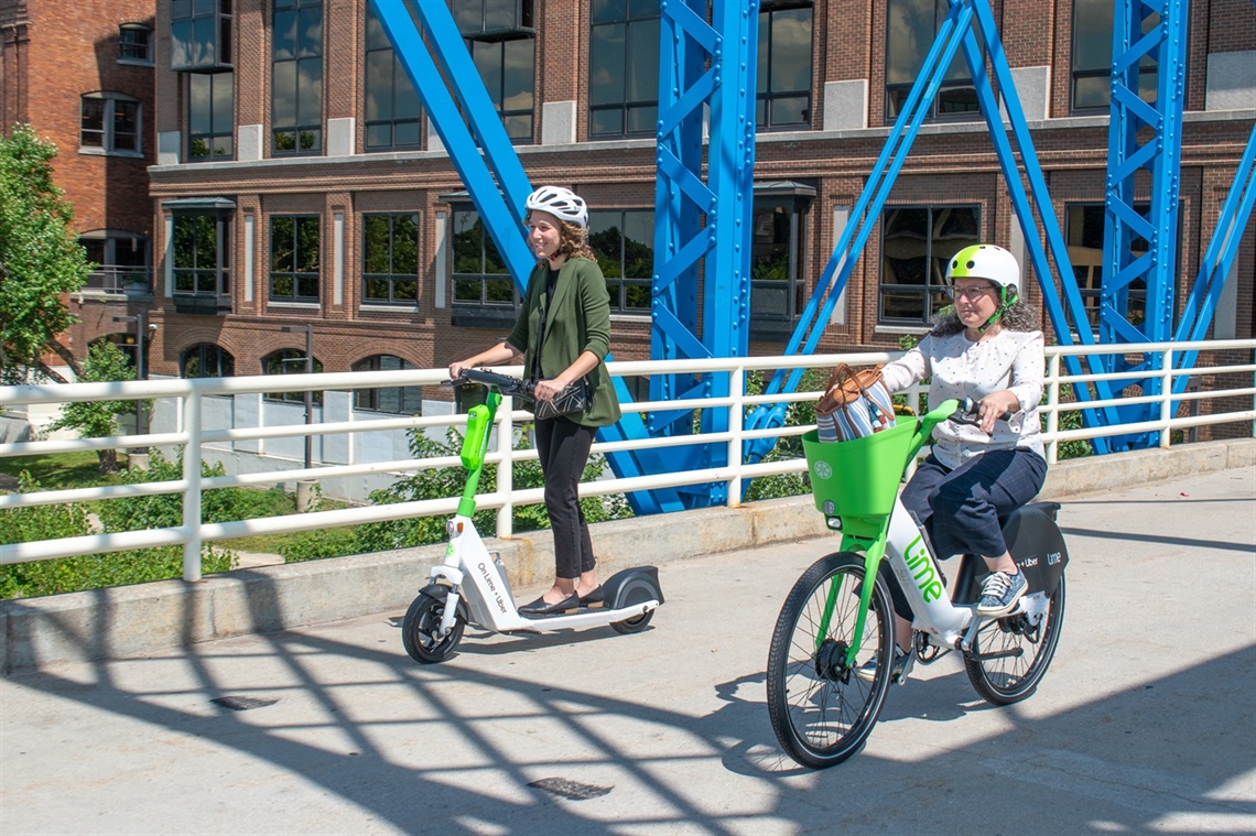 Two People riding on shared micromobility devices