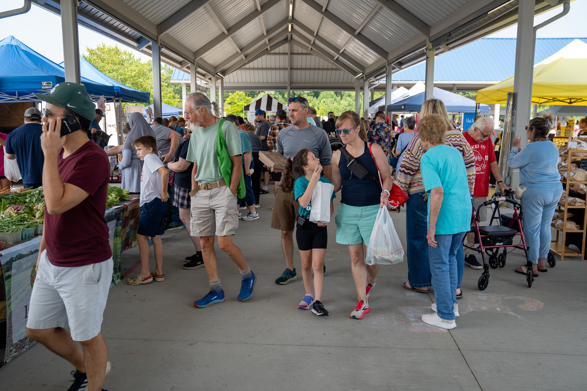 People walking around the Meridian Township Farmers' Market at Marketplace on the Green