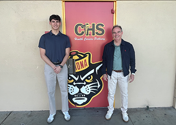 Elijah Kozloff stands with teacher Mr. Winn outside of CHS classroom door