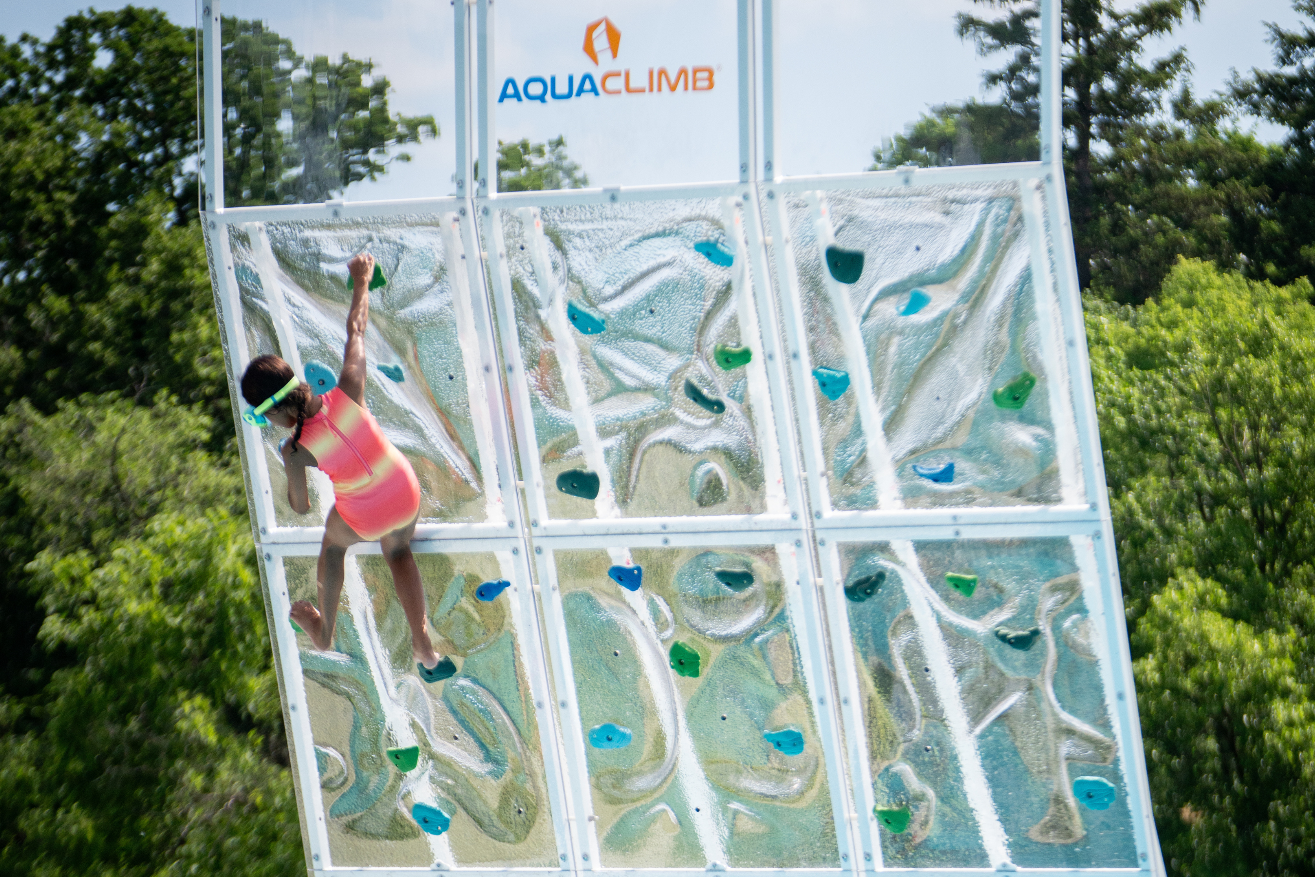 a child climbing a rock wall at the silver lake aquatics area