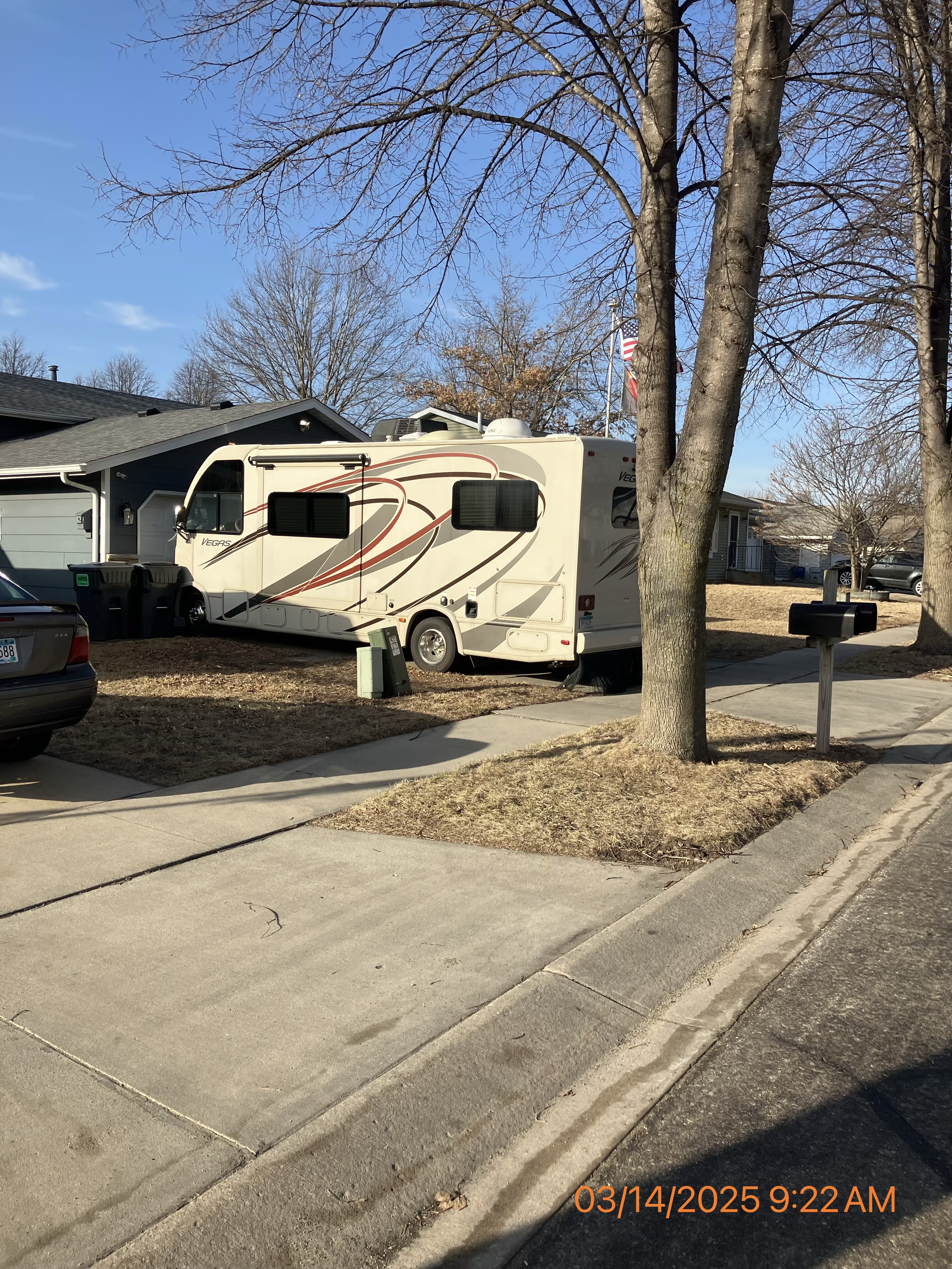 A recreational vehicle located on a paved, private driveway which is in compliance with local codes.